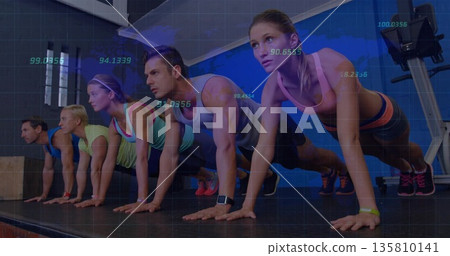 Holding plank position class participants on platform in gym studio, with wrist fitness trackers 135810141