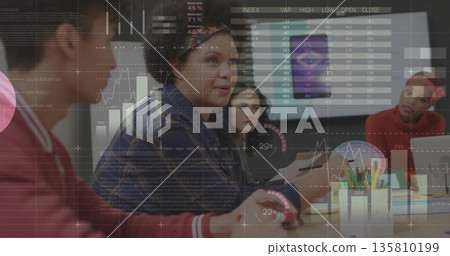 Presenting woman in denim jacket gesturing toward financial charts in modern office, with display Presenting woman in denim jacket gesturing toward financial charts in modern office, with display 135810199