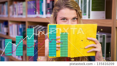 Peering teenage student holding yellow book in library, with chart overlay and sparkles Peering teenage student holding yellow book in library, with chart overlay and sparkles 135810209
