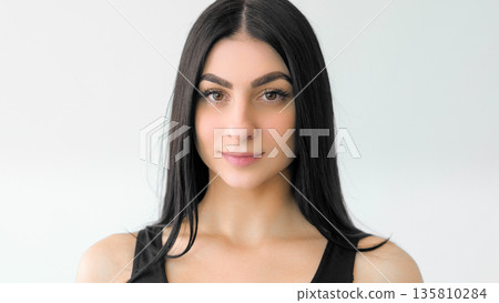 Young charm. Model girl. Natural portrait of woman with healthy glowing face with minimal makeup. Attractive female isolated on white. 135810284