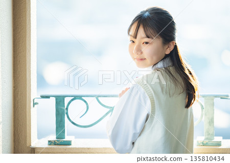 After school, a female junior high school student looks outside 135810434