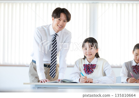 Students and instructors studying at a cram school Students and instructors studying at a cram school 135810664