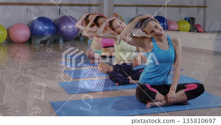 Stretching coach in sportswear leading neck stretch in studio with yoga mats, copy space Stretching coach in sportswear leading neck stretch in studio with yoga mats, copy space 135810697