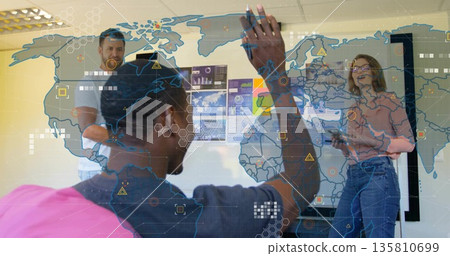 Group of three professionals collaborating in office meeting room, with world map and tablet Group of three professionals collaborating in office meeting room, with world map and tablet 135810699