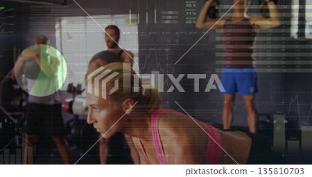 Woman in pink top bracing for lift in weight gym, with medicine ball and metrics overlay Woman in pink top bracing for lift in weight gym, with medicine ball and metrics overlay 135810703