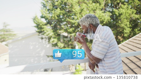Leaning masked man wearing polo shirt sipping mug on balcony railing, with like icon, copy space Leaning masked man wearing polo shirt sipping mug on balcony railing, with like icon, copy space 135810738