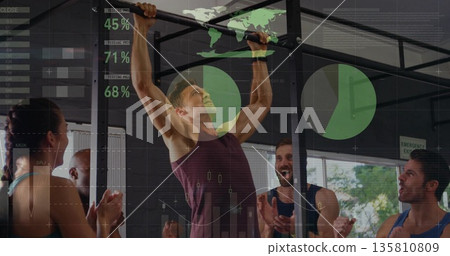 Performing pull-up man in burgundy sleeveless top climbing rig at gym with graphics overlay 135810809