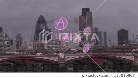Floating translucent network sphere hovering over London riverside, with red bridge and skyline 135810967