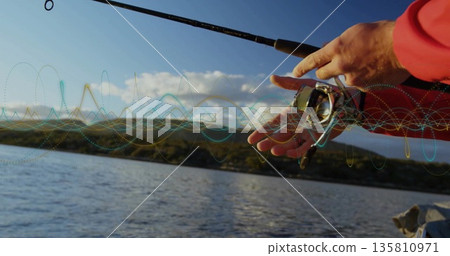 Gripping spinning rod and adjusting reel-drag knob in red jacket on boat at lake, copy space Gripping spinning rod and adjusting reel-drag knob in red jacket on boat at lake, copy space 135810971