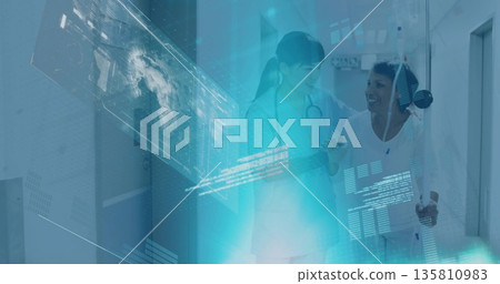 Walking patient with IV pole down ward corridor, doctor with stethoscope reviewing tablet interface Walking patient with IV pole down ward corridor, doctor with stethoscope reviewing tablet interface 135810983