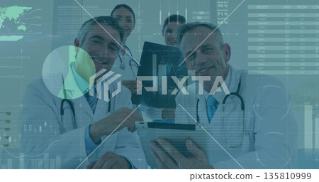 Examining team of doctors analyzing metrics in consultation room, with tablet X-ray film charts 135810999