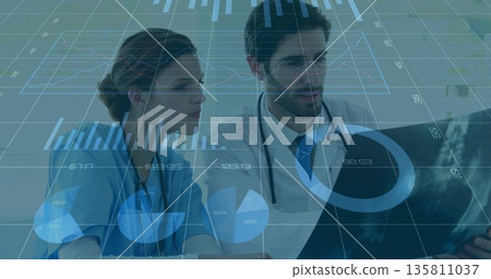 Examining physician and nurse reviewing digital X-ray in lab, with graphs, tablet and stethoscopes Examining physician and nurse reviewing digital X-ray in lab, with graphs, tablet and stethoscopes 135811037