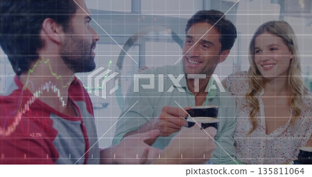 Friends wearing casual attire toasting at kitchen table, with coffee mugs, financial chart overlay 135811064