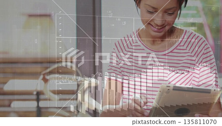 Smiling adult woman checking tablet near sliding door, with financial graph overlays, copy space Smiling adult woman checking tablet near sliding door, with financial graph overlays, copy space 135811070