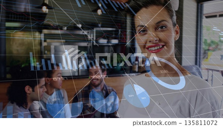 Smiling businesswoman wearing white blouse reviewing digital charts in coffee shop, copy space Smiling businesswoman wearing white blouse reviewing digital charts in coffee shop, copy space 135811072