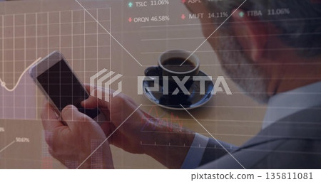 Tapping smartphone businessman at wooden cafe table with coffee cup on saucer, stock market overlay Tapping smartphone businessman at wooden cafe table with coffee cup on saucer, stock market overlay 135811081
