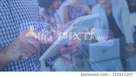 Holding white tablet man in shirt presenting data at conference table, with follower-count overlay Holding white tablet man in shirt presenting data at conference table, with follower-count overlay 135811107