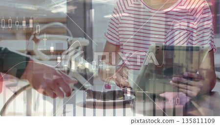 Sitting woman holding tablet and mug at cafe table, with cake slice and financial charts overlay Sitting woman holding tablet and mug at cafe table, with cake slice and financial charts overlay 135811109