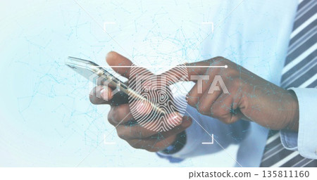 Verifying hands in shirt scanning fingerprint icon on smartphone in office, with network overlay Verifying hands in shirt scanning fingerprint icon on smartphone in office, with network overlay 135811160