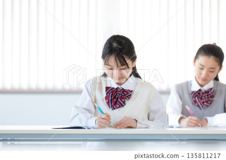 Junior high school girls studying at cram school 135811217