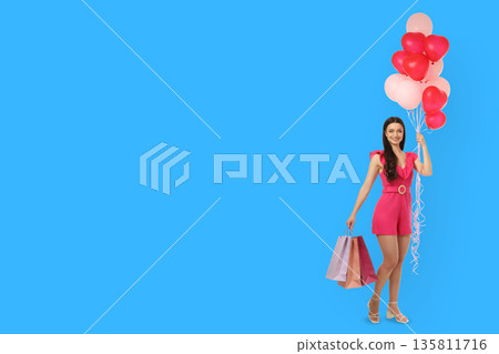 Woman in pink outfit stands with balloons and shopping bags Woman in pink outfit stands with balloons and shopping bags 135811716