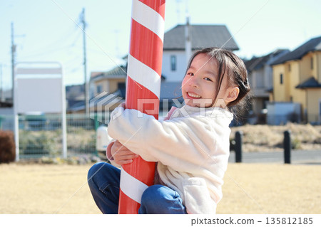 A girl playing in a park in winter A girl playing in a park in winter 135812185