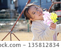 A girl playing in a park in winter 135812834