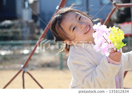 A girl playing in a park in winter A girl playing in a park in winter 135812834