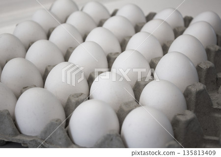 These are white eggs in an egg carton. 135813409