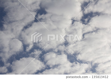 The sky is covered with fluffy clouds 135813412
