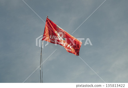 Liverpool F.C. Flag waving with the blue sky background. Liverpool F.C. Flag waving with the blue sky background. 135813422