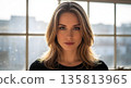 Confident businesswoman standing in modern office with natural light 135813965