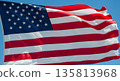 American flag waving proudly against clear blue sky 135813968