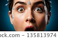 Shocked woman with water splashing on her face against blue background 135813974