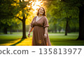 Happy young woman enjoying nature in serene park at sunset 135813977