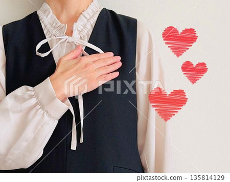 Woman with hands on chest + heart 135814129