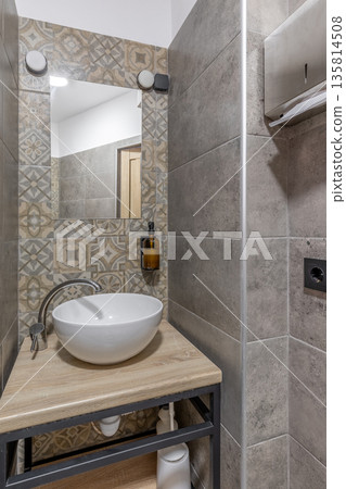 Compact bathroom vanity with vessel sink and patterned tiles Compact bathroom vanity with vessel sink and patterned tiles 135814508