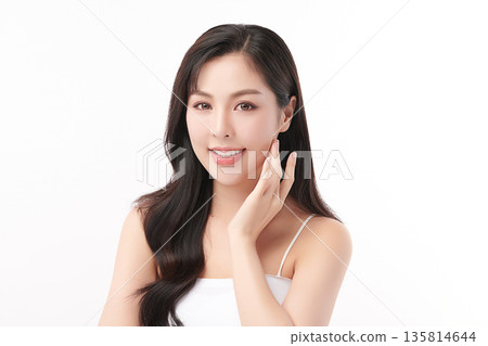 A beautiful young Asian woman with clean, fresh skin against a white background. Skincare, facial treatment, cosmetology, beauty, and spa. An elegant portrait of an Asian woman. A beautiful young Asian woman with clean, fresh skin against a white background. Skincare, facial treatment, cosmetology, beauty, and spa. An elegant portrait of an Asian woman. 135814644