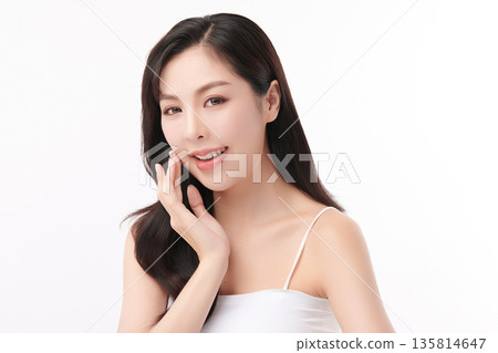 A beautiful young Asian woman with clean, fresh skin against a white background. Skincare, facial treatment, cosmetology, beauty, and spa. An elegant portrait of an Asian woman. A beautiful young Asian woman with clean, fresh skin against a white background. Skincare, facial treatment, cosmetology, beauty, and spa. An elegant portrait of an Asian woman. 135814647