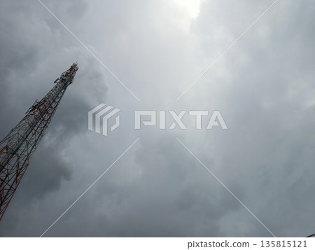 Mobile Signal Transmitter Tower in Corner View Against Moody Sky 135815121
