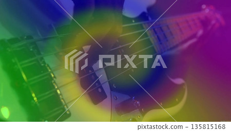 Plucking bassist's hand fretting electric bass guitar steel strings onstage, with colorful lights Plucking bassist's hand fretting electric bass guitar steel strings onstage, with colorful lights 135815168