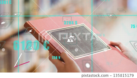 Showing student hands holding red book in library, casting grid with power lightning currency icons Showing student hands holding red book in library, casting grid with power lightning currency icons 135815179