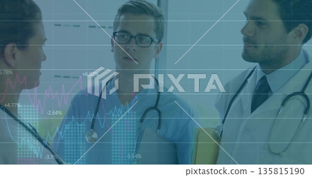 Reviewing charts, medical team discussing metrics in hospital corridor, blinds, stethoscopes folder Reviewing charts, medical team discussing metrics in hospital corridor, blinds, stethoscopes folder 135815190