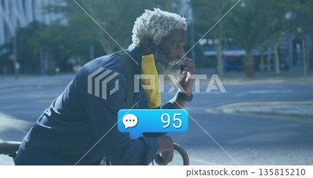 Leaning cyclist wearing yellow gaiter on bicycle curbside with basket, chat bubble with 95 alerts 135815210