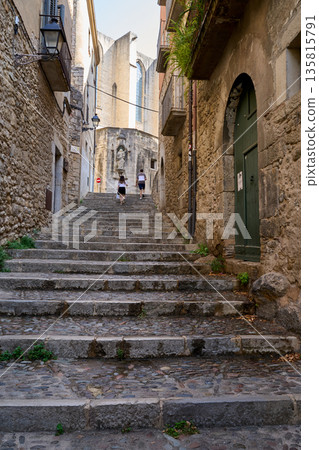 A Medieval street with stairs in the city of Girona, Catalonia, Spain. A Medieval street with stairs in the city of Girona, Catalonia, Spain. 135815791