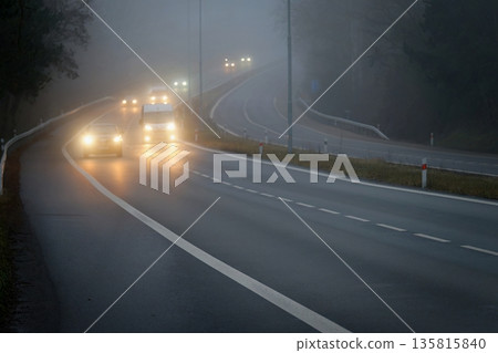Bad weather driving foggy hazy country road. Motorway  road traffic. Winter time 135815840