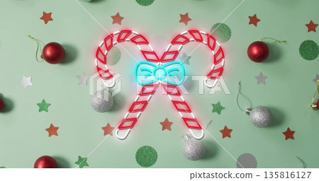 Image of flickering christmas sugar cain over christmas decorations Image of flickering christmas sugar cain over christmas decorations 135816127