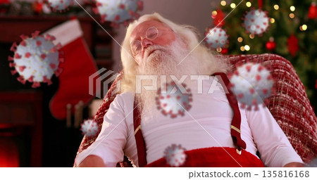 Image of covid 19 cells moving over sleeping santa claus in armchair in the background Image of covid 19 cells moving over sleeping santa claus in armchair in the background 135816168