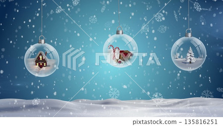Three hanging bauble decoration and snowflakes falling over winter landscape 135816251