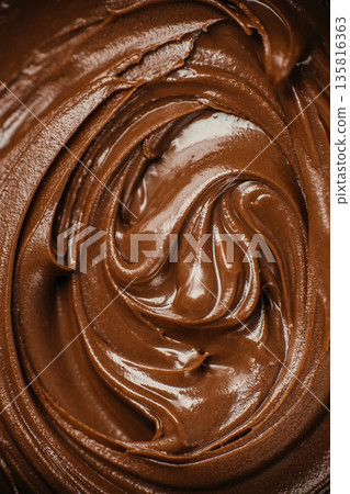 Creamy melted chocolate swirl texture background Creamy melted chocolate swirl texture background 135816363